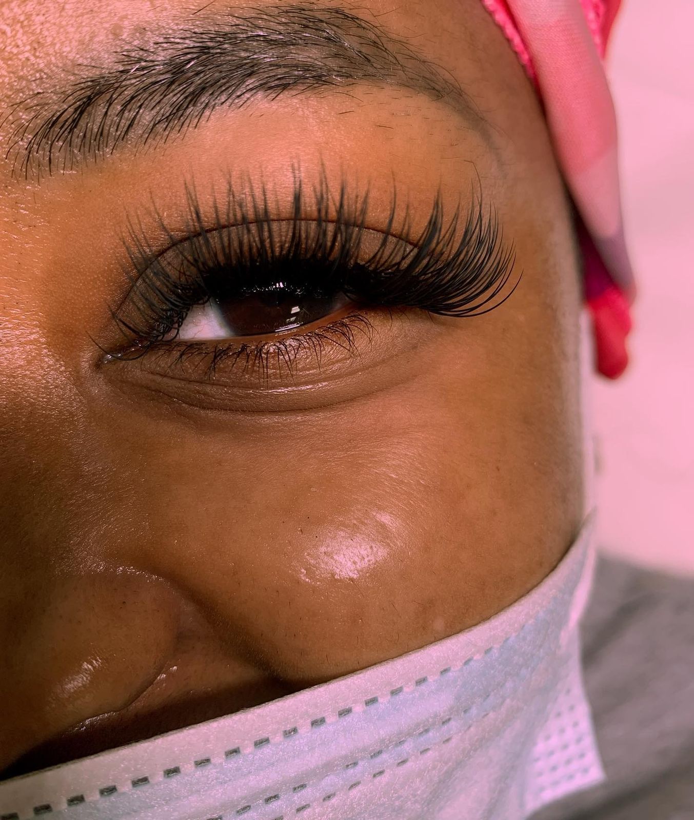 Full fluffy lash set, close up against a pink backdrop