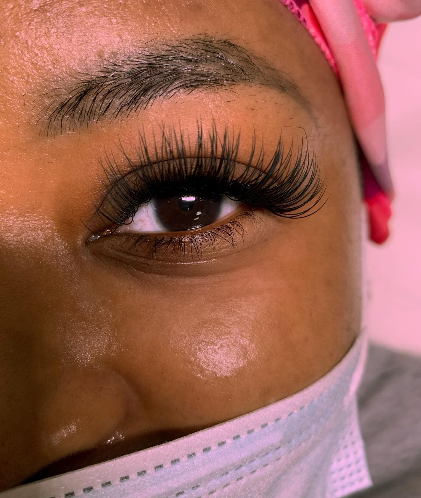 Full fluffy set against a pink backdrop, a close-up of her work